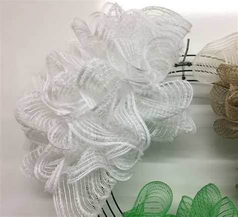 Twist your chenille stems to hold it into place. . Pull through deco mesh wreath